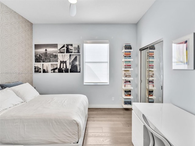 bedroom with a closet, multiple windows, and hardwood / wood-style floors