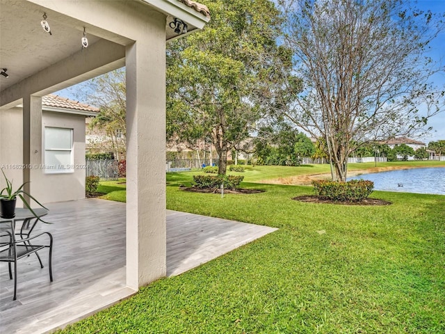 view of yard with a deck with water view