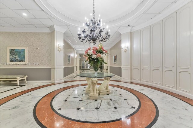 misc room featuring a notable chandelier and a drop ceiling