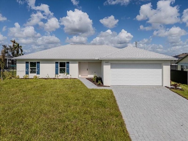 ranch-style house featuring a front lawn and a garage