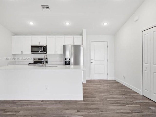 kitchen with white cabinetry, stainless steel appliances, light hardwood / wood-style flooring, and sink