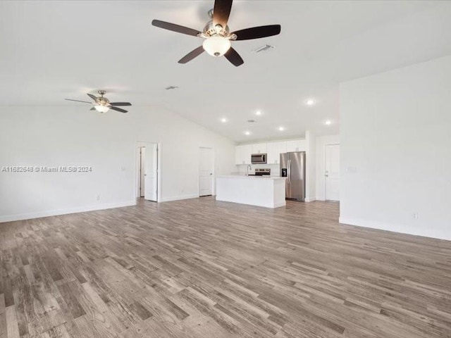 unfurnished living room with lofted ceiling, hardwood / wood-style floors, and ceiling fan