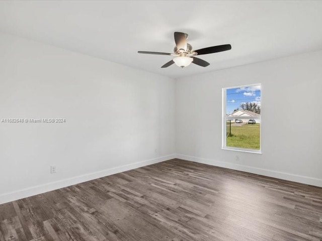 empty room with dark wood-type flooring and ceiling fan