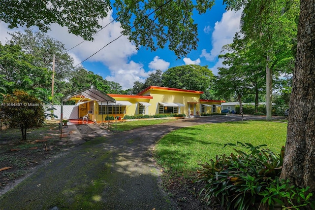 exterior space featuring a front yard and a carport