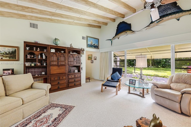 living room featuring beamed ceiling, carpet floors, and ceiling fan