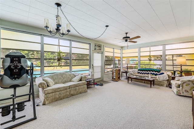 sunroom / solarium featuring ceiling fan with notable chandelier