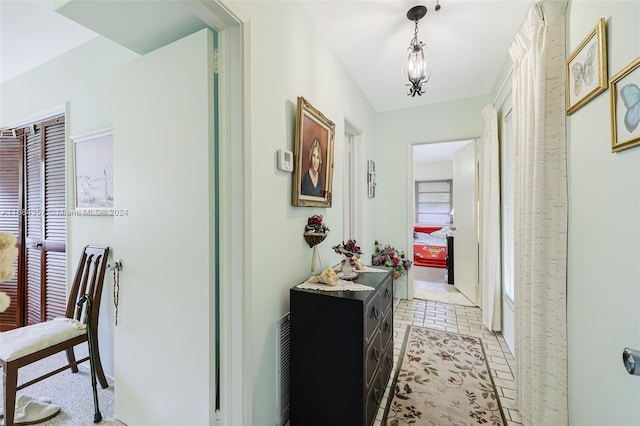 hall featuring light tile patterned floors