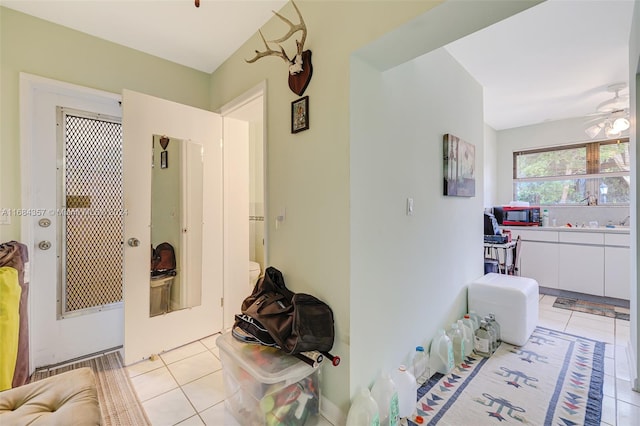 hall featuring light tile patterned flooring