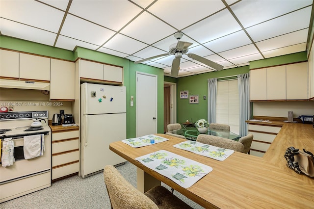 kitchen with white appliances, ceiling fan, butcher block countertops, and white cabinetry