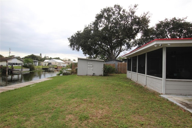 view of yard with a water view and a storage unit