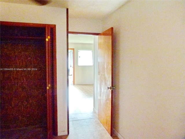 hallway featuring light tile patterned floors