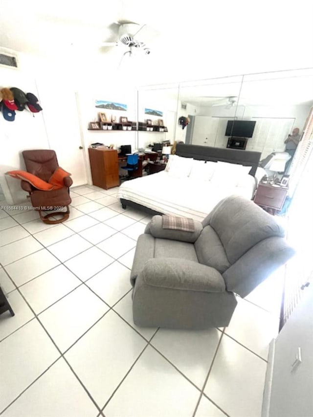 living room with light tile patterned floors and ceiling fan