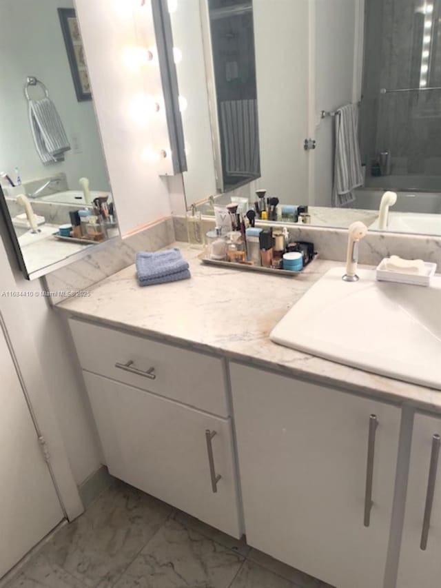 bathroom featuring washtub / shower combination and vanity