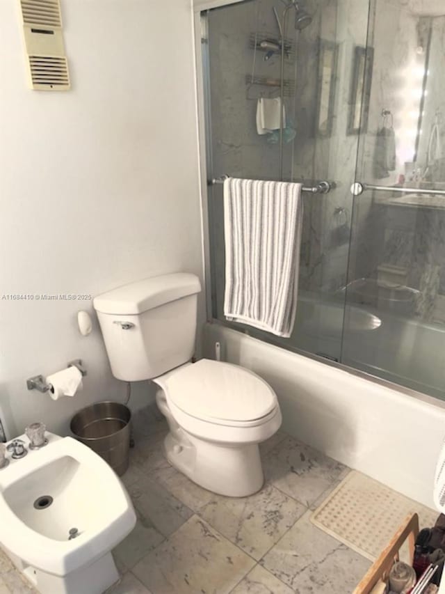 265 Grapetree Dr Unit 108, Key Biscayne, FL 33149 - bathroom with toilet, combined bath / shower with glass door, a bidet, and marble finish floors