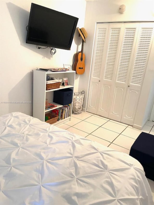 tiled bedroom with a closet