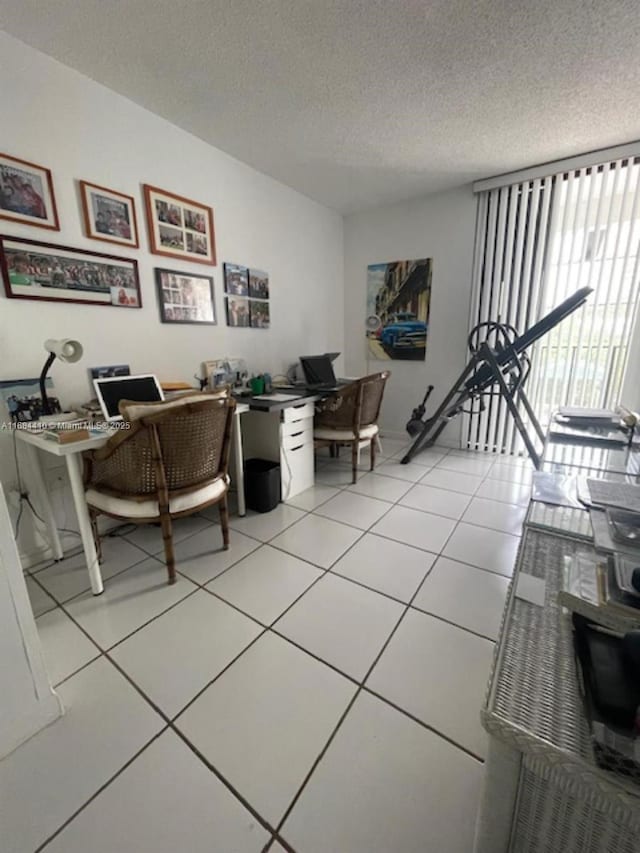 home office featuring light tile patterned flooring and a textured ceiling