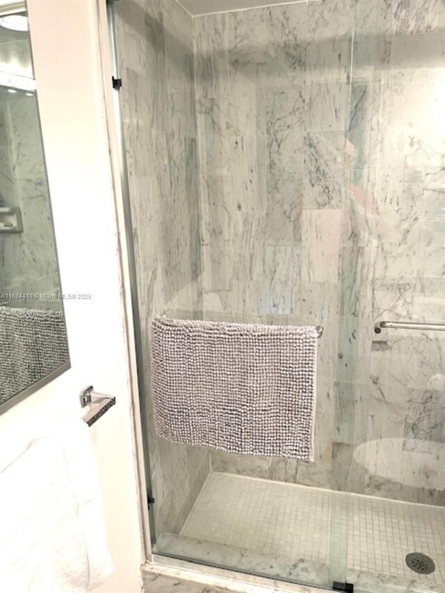 bathroom with a tile shower