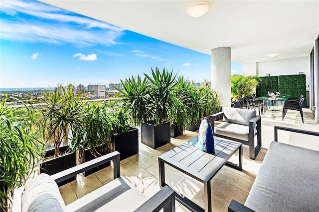 balcony with an outdoor living space and a patio area