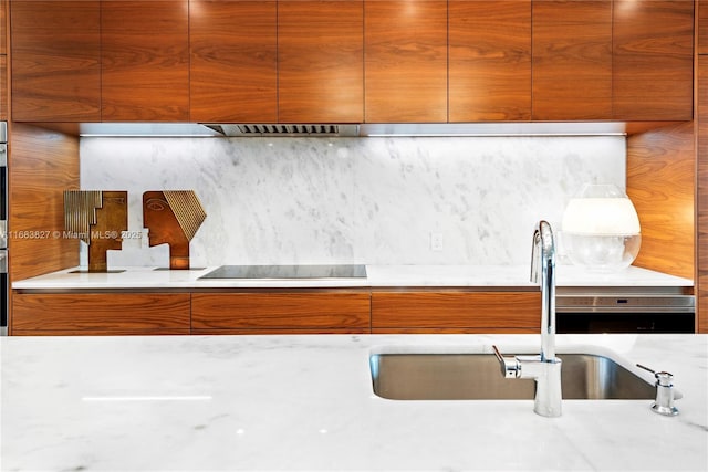 kitchen with sink, black electric stovetop, and backsplash