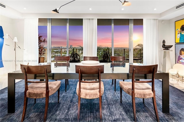 dining space featuring a wall of windows