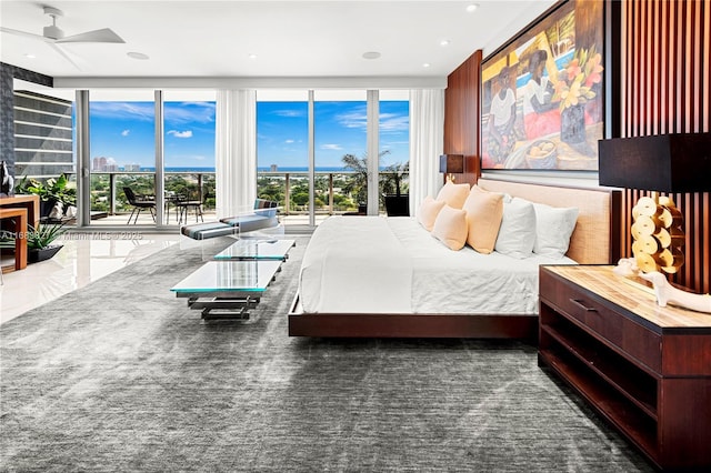 bedroom featuring a wall of windows and access to outside