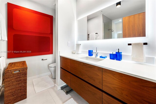 bathroom with tile patterned flooring, vanity, toilet, and walk in shower