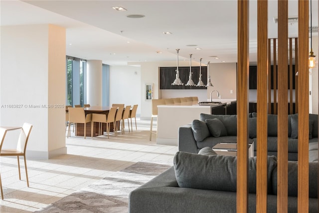 living room featuring light tile patterned floors and sink