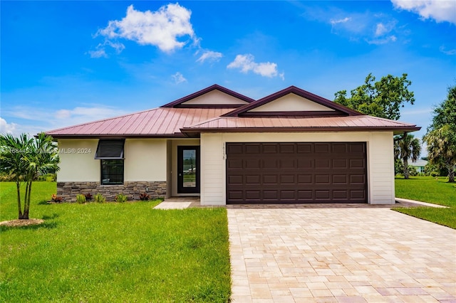 view of front facade with a front lawn and a garage