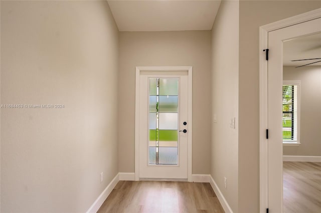 doorway featuring light wood-type flooring and ceiling fan