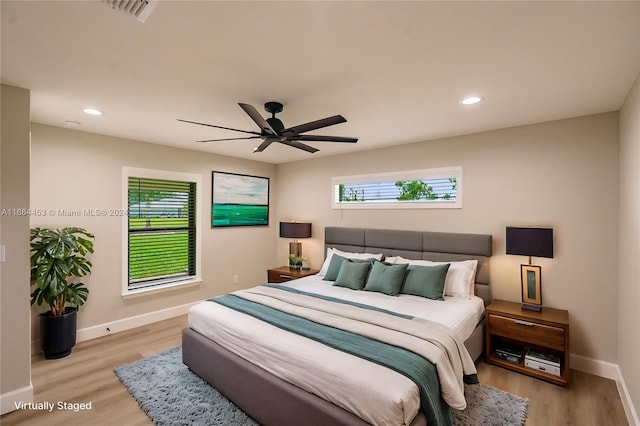 bedroom with light wood-type flooring and ceiling fan