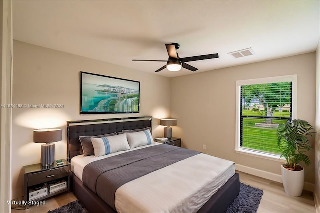 bedroom with light hardwood / wood-style floors and ceiling fan