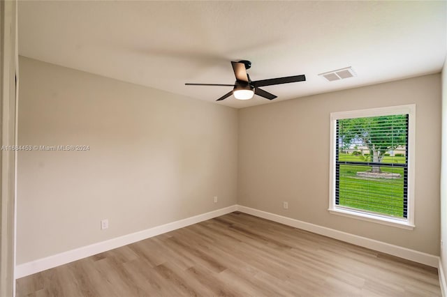 empty room with light hardwood / wood-style floors and ceiling fan