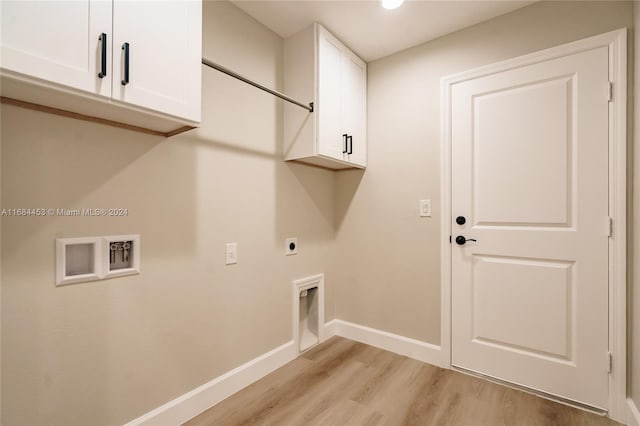 washroom with cabinets, hookup for an electric dryer, washer hookup, and light hardwood / wood-style floors