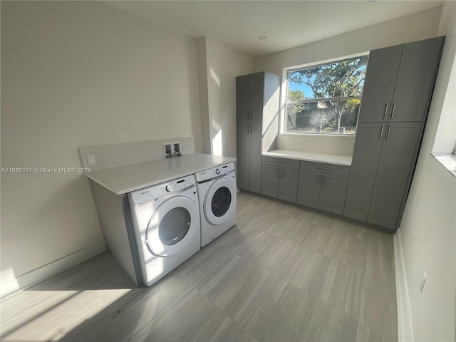 laundry area featuring cabinets and independent washer and dryer