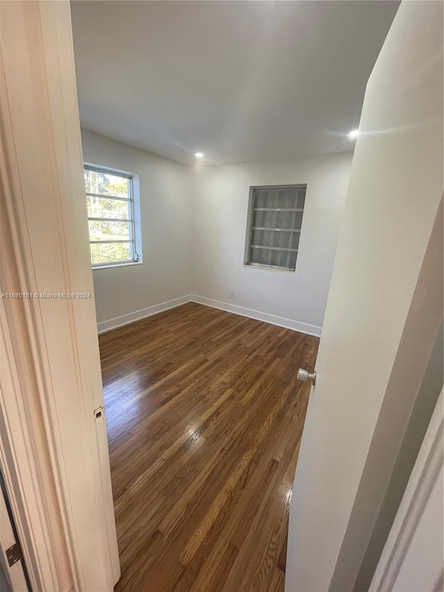 unfurnished room with dark hardwood / wood-style floors