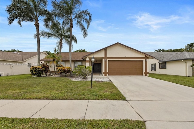 ranch-style house featuring a front yard and a garage