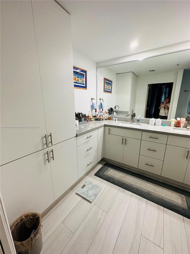 bathroom with vanity and hardwood / wood-style floors