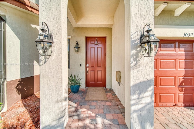 doorway to property featuring ceiling fan