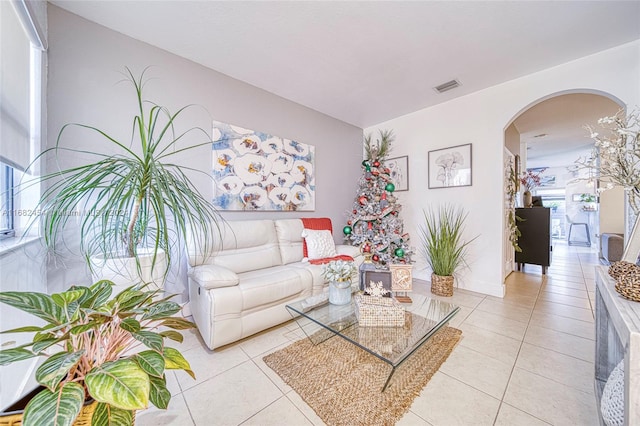 living room with plenty of natural light and light tile patterned floors