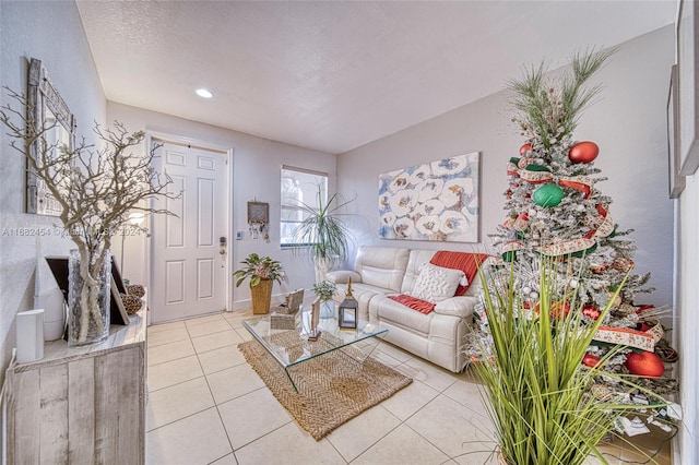 living room featuring a textured ceiling and light tile patterned flooring