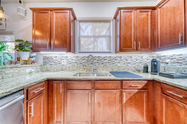 kitchen with light stone counters, tasteful backsplash, sink, and dishwasher