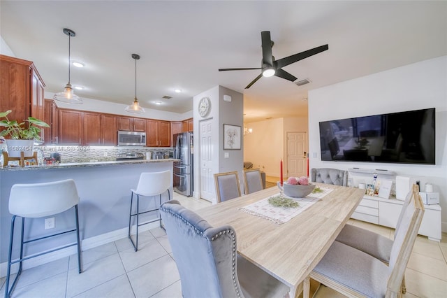 dining area with ceiling fan and light tile patterned floors