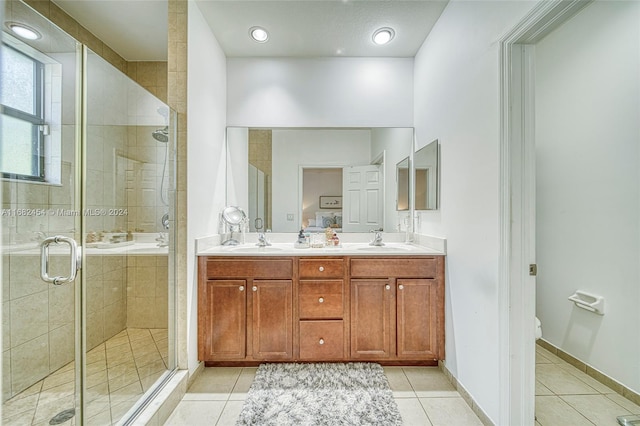 bathroom with vanity, an enclosed shower, and tile patterned flooring