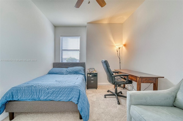 bedroom featuring ceiling fan and light carpet