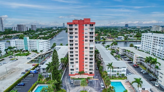 exterior space featuring a community pool and a water view