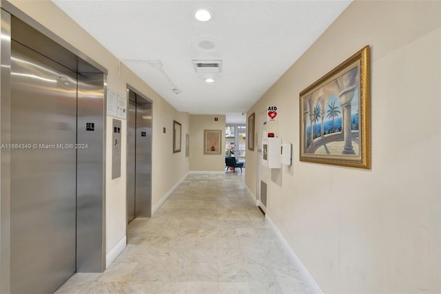 3161 S Ocean Dr Unit 203, Hallandale Beach, FL 33009 - corridor featuring elevator, light marble finish flooring, and baseboards