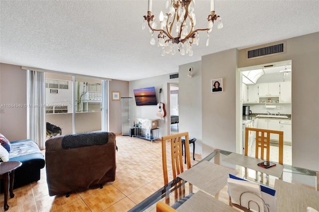 3161 S Ocean Dr Unit 203, Hallandale Beach, FL 33009 - dining space featuring a textured ceiling, healthy amount of natural light, a chandelier, and light tile patterned floors
