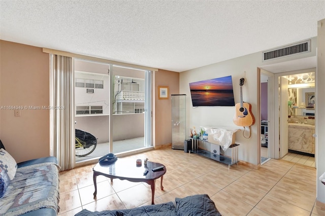 tiled living room featuring a textured ceiling and sink