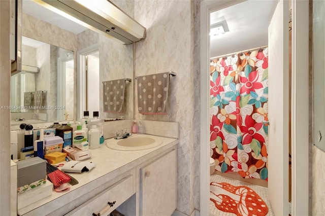 bathroom featuring vanity, a shower with curtain, and toilet