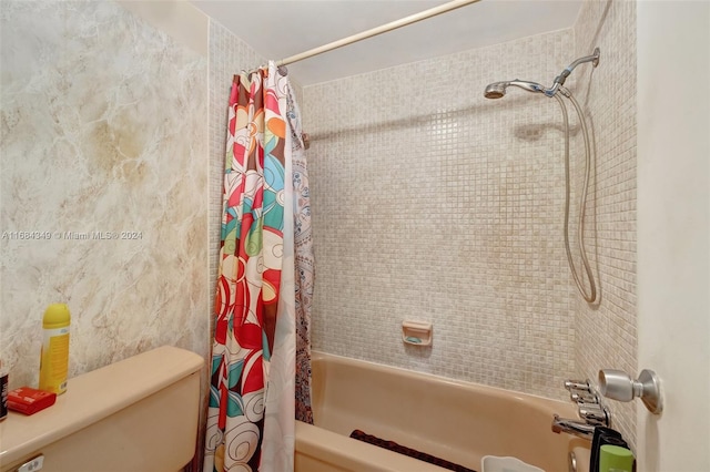 bathroom featuring toilet and shower / bathtub combination with curtain